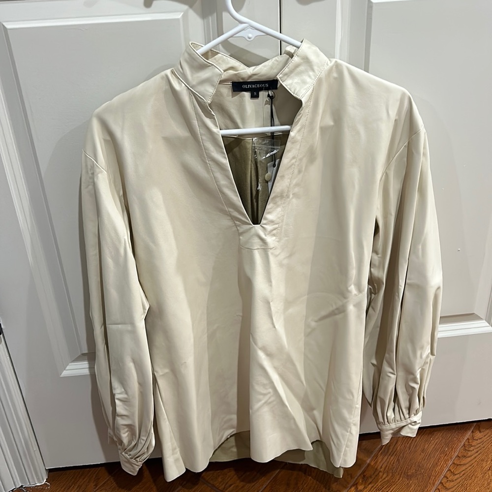 Olivaceous cream colored leather top. New with tags size small.